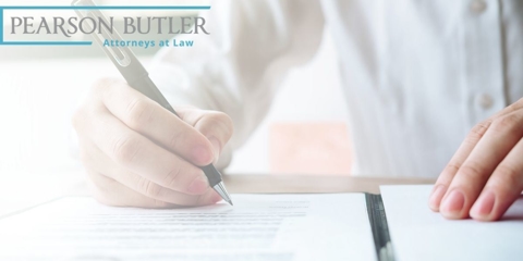 Man using pen to sign a paper